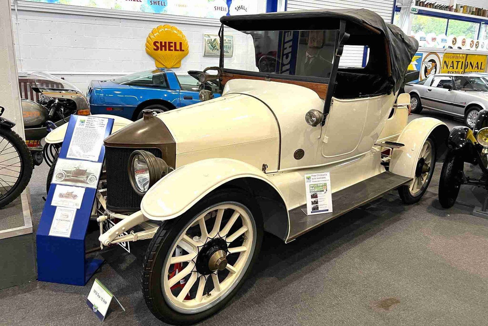 Vintage cream car with a black hood at Lakeland Motor Museum